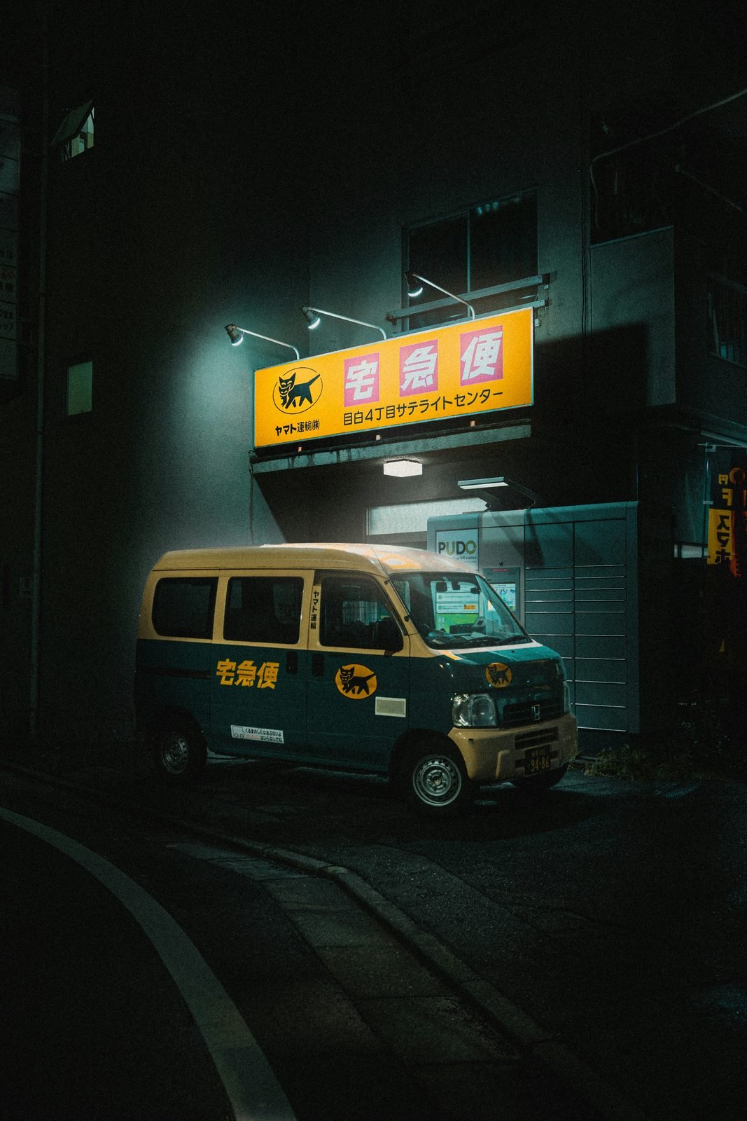 A Yamato delivery van on a Tokyo street at night